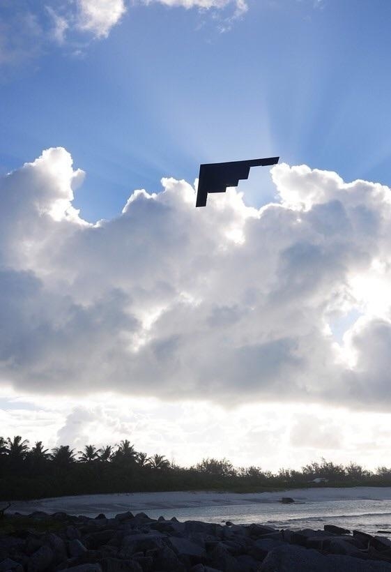 A pixelated black patch appears in the middle of blue sky with fluffy white clouds