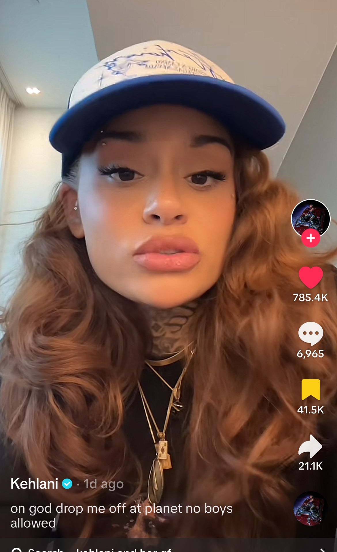 Singer Kehlani wearing a blue and white cap, seen in a TikTok video with the caption, &quot;on god drop me off at planet no boys allowed.&quot; The video has 785.4K likes