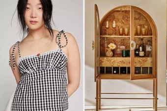 Model in a gingham-patterned top stands next to a wooden cabinet displaying glassware, bottles, and decorative items