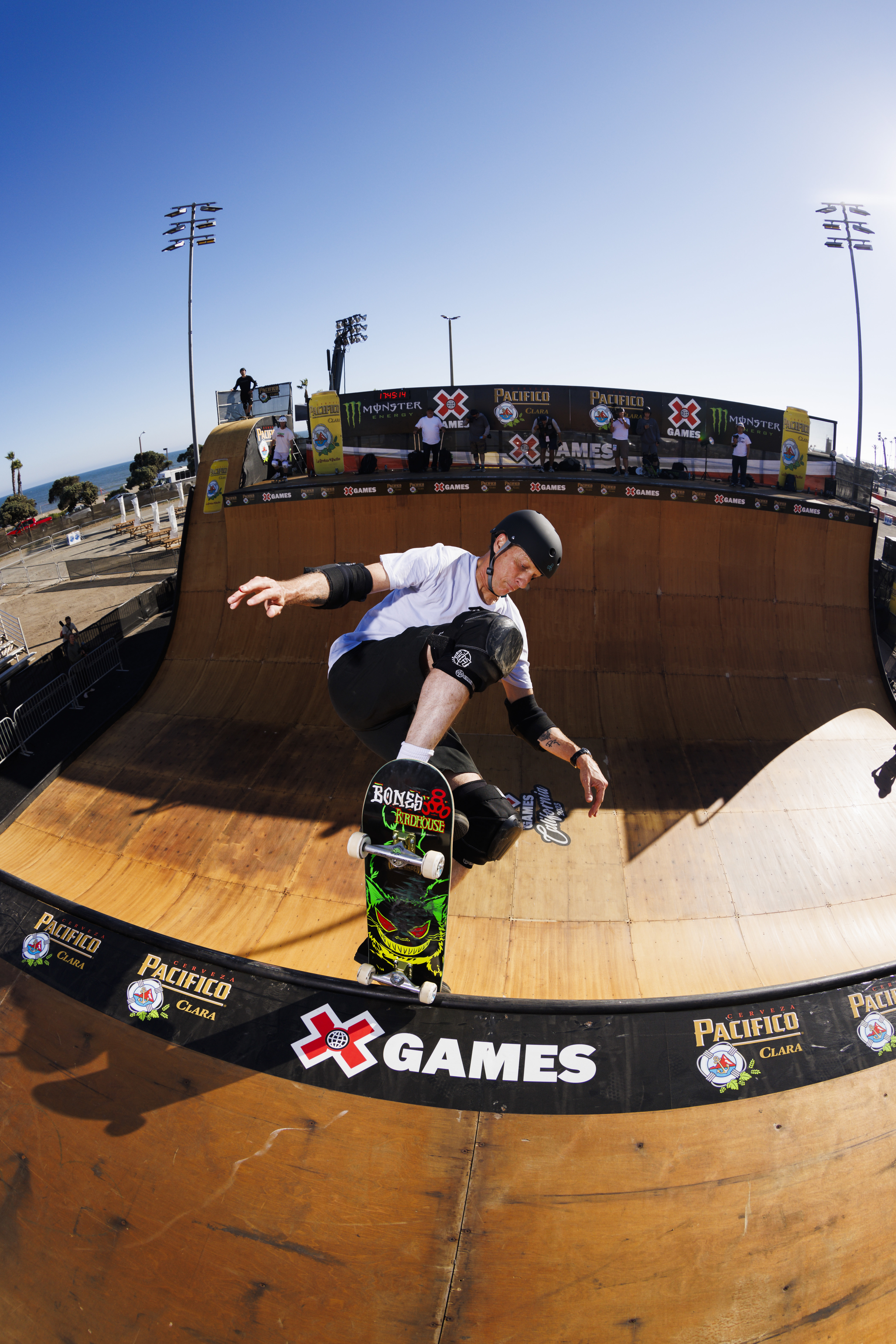 Tony Hawk performs a skateboard trick on a ramp at the X Games