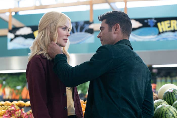 Nicole Kidman and Zac Efron in a grocery store scene, with Zac touching Nicole&#x27;s face gently. Both are dressed casually