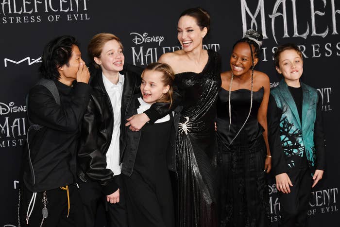 Angelina Jolie and children Pax, Shiloh, Vivienne, Zahara, and Knox on the red carpet in stylish attire at the Maleficent: Mistress of Evil premiere