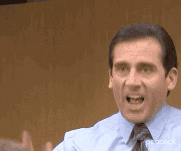 Steve Carell&#x27;s character, Michael Scott, from &quot;The Office,&quot; is yelling and gesturing with his hands in a comical and animated manner