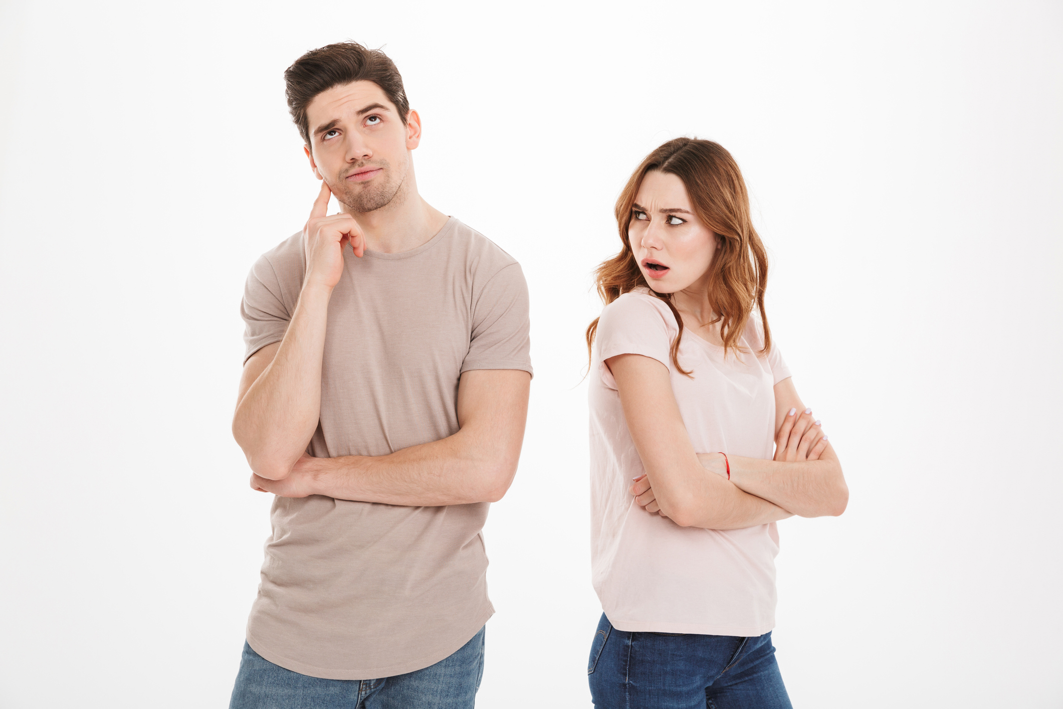 A man and a woman standing back to back. The man appears to be thinking with his hand on his chin, while the woman looks at him with an expression of surprise or annoyance