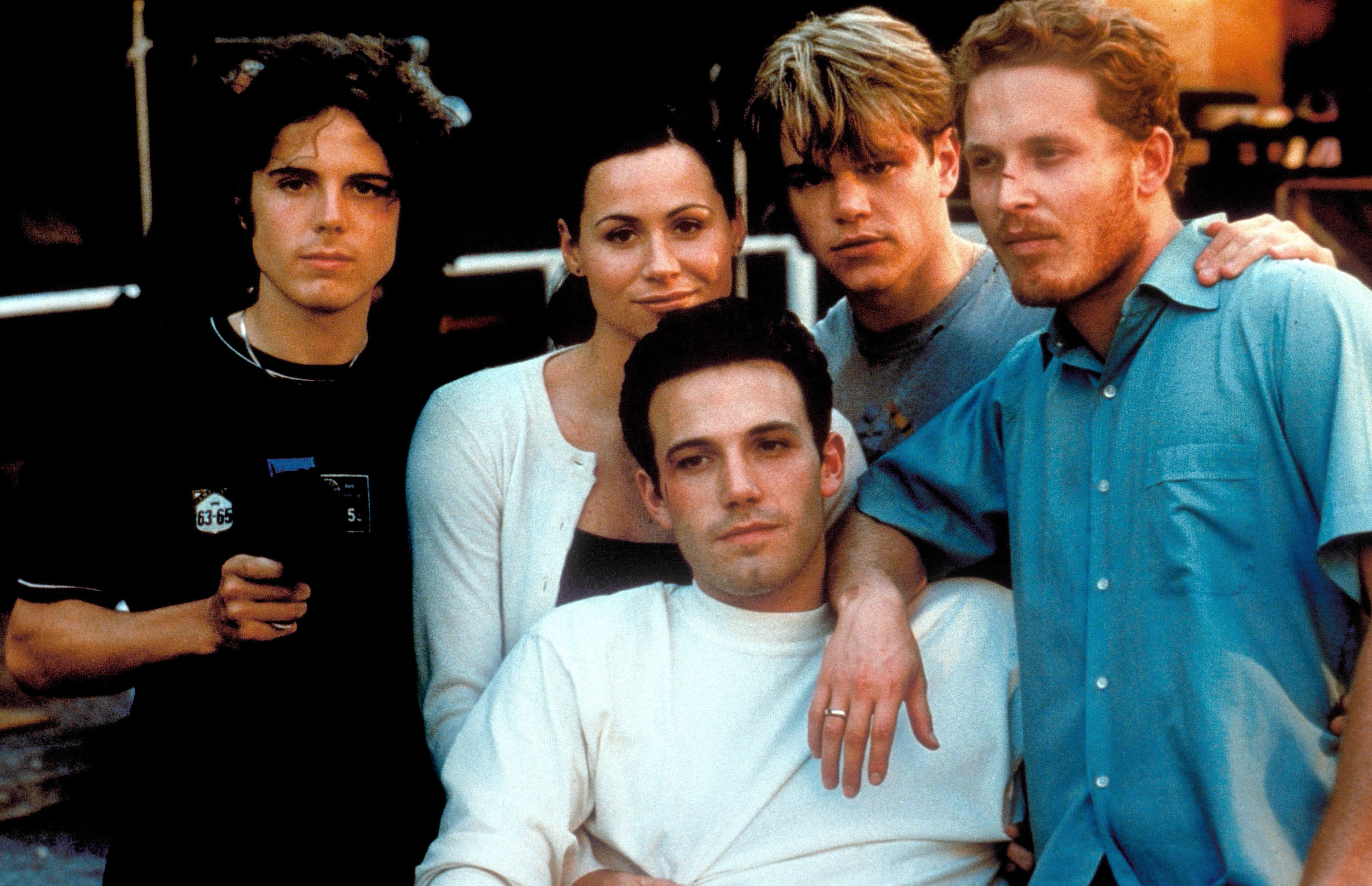 Ben Affleck, Matt Damon, Cole Hauser, Minnie Driver, and Casey Affleck pose closely together in casual attire