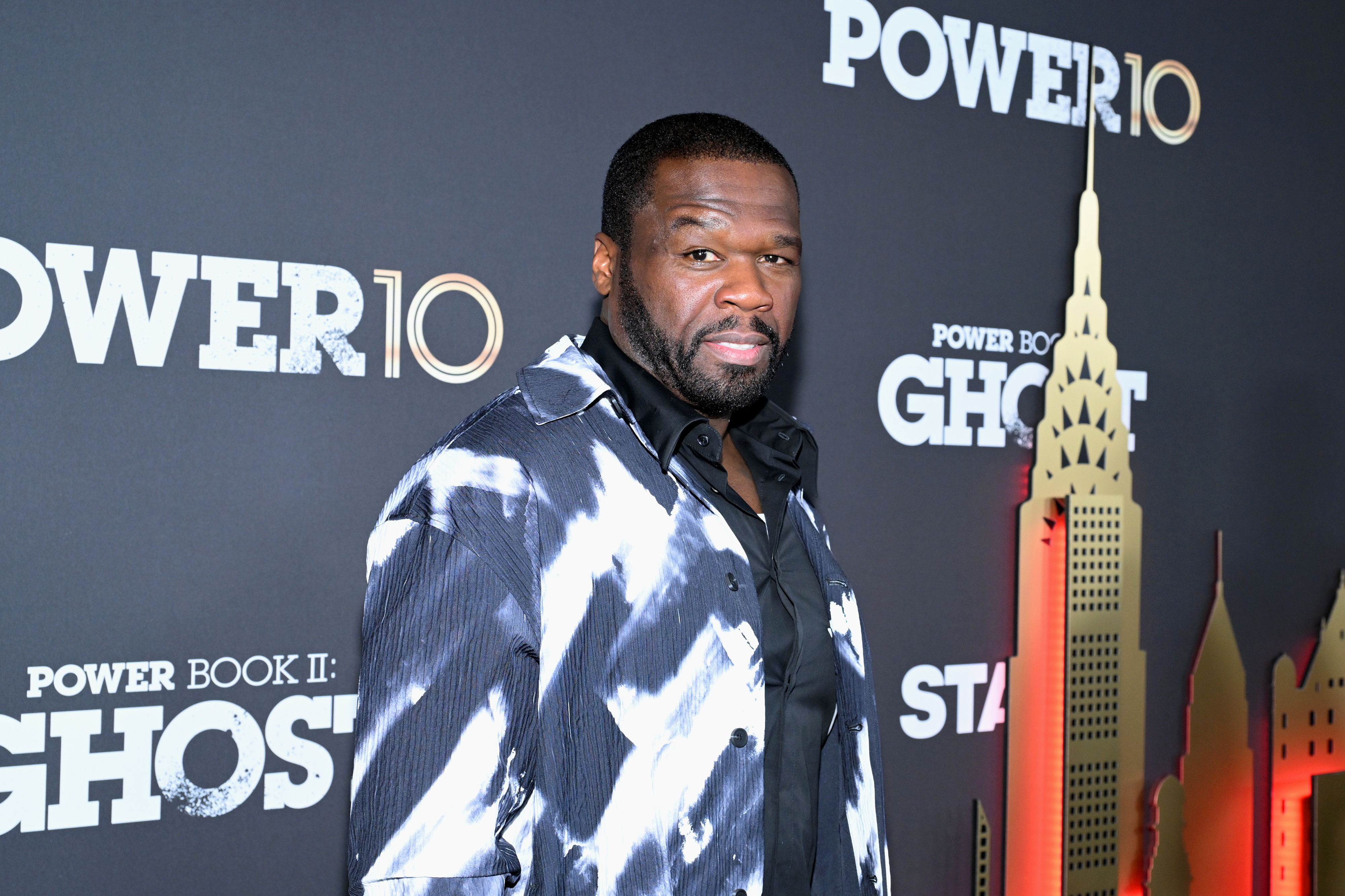 50 Cent on the red carpet at the &quot;Power Book II: Ghost&quot; premiere wearing a patterned jacket over a black shirt