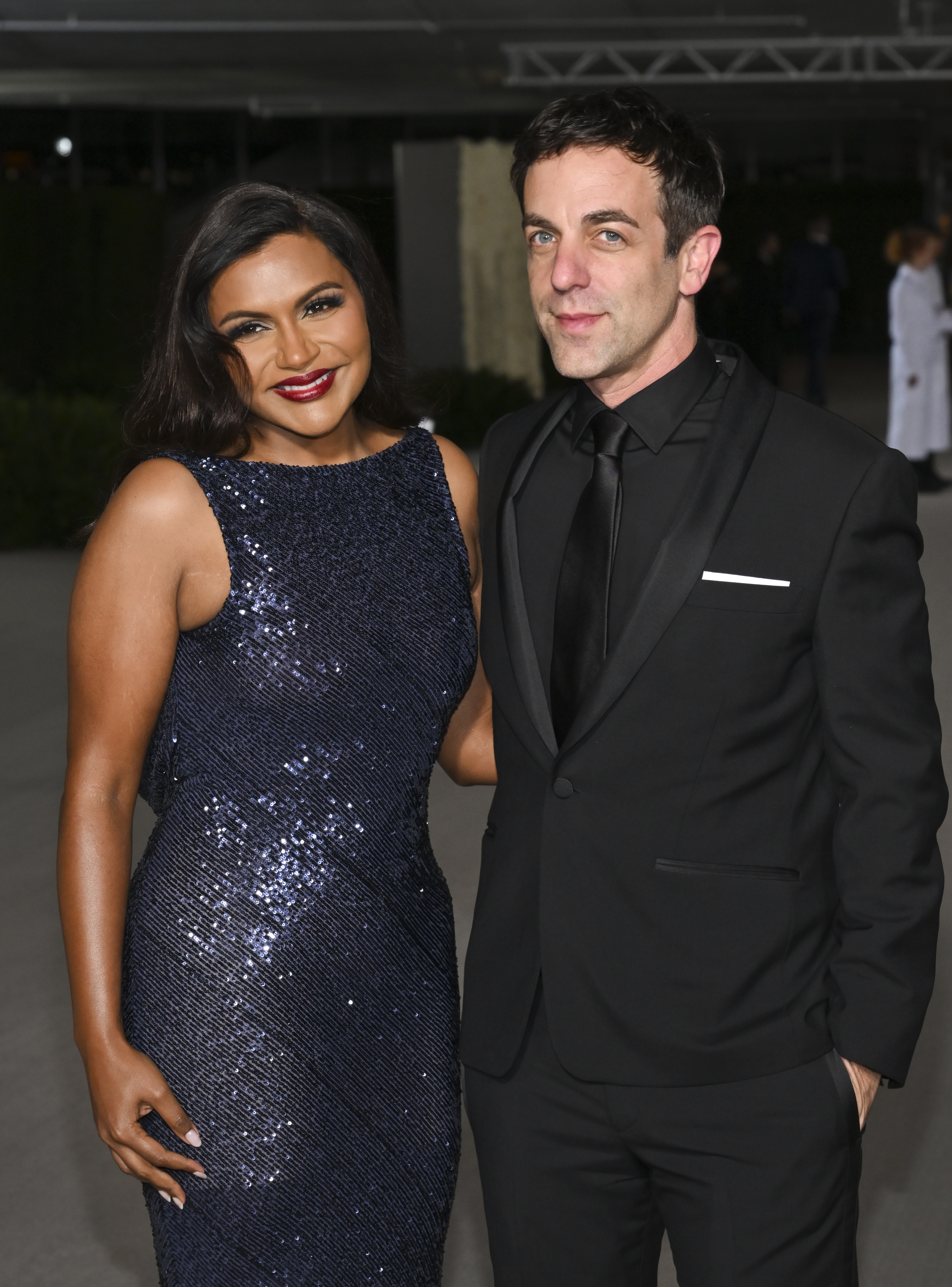 Mindy Kaling in a sequined dress and B.J. Novak in a black suit pose together at an event