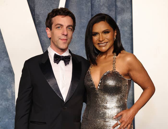 B.J. Novak and Mindy Kaling at a formal event, with Novak in a tuxedo and Kaling in a sleeveless metallic dress