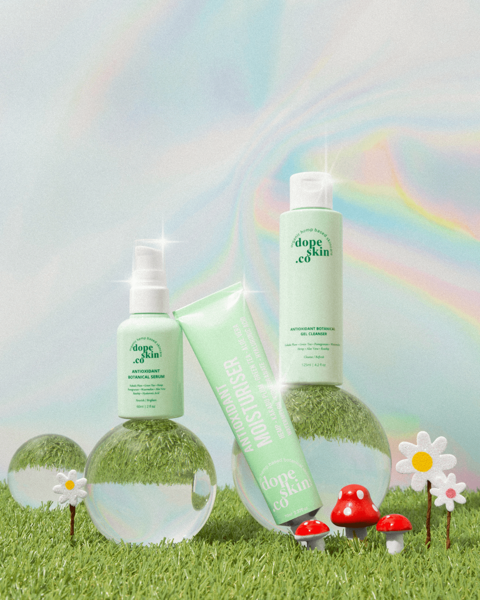 Three Dope Skin skincare products displayed on grass with glass spheres, mushrooms, and flowers in the background