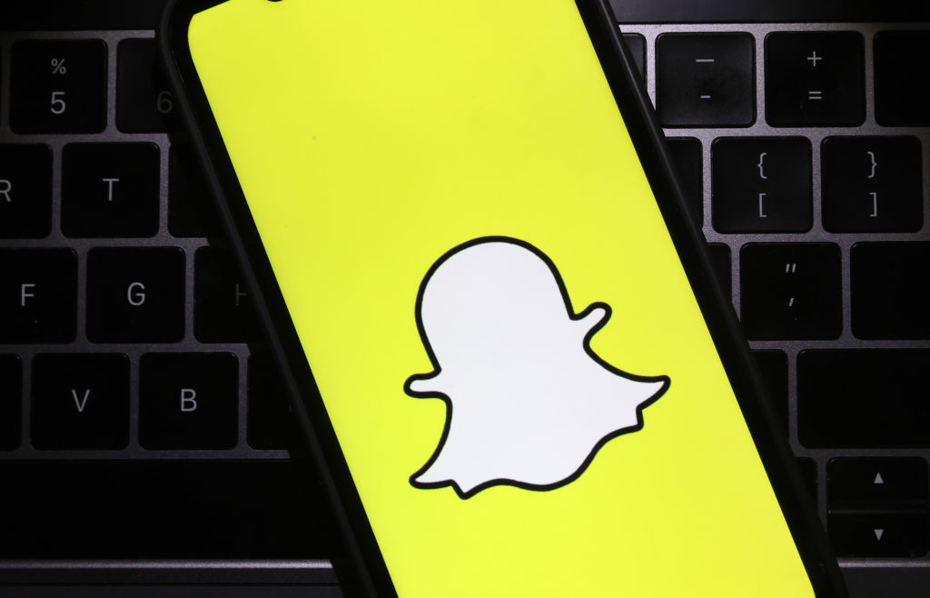 Smartphone displaying the Snapchat logo on a keyboard