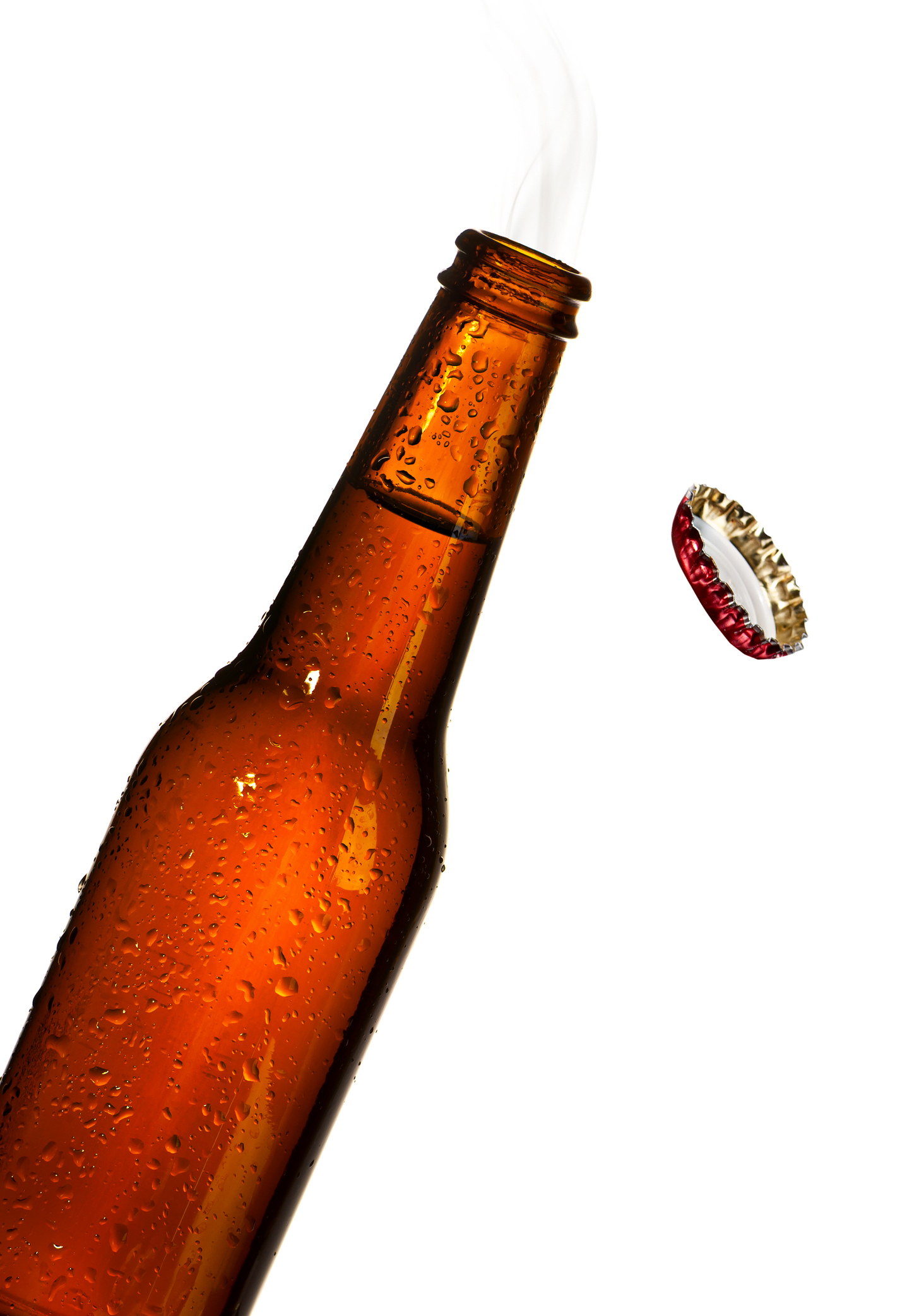 A brown glass beer bottle emits steam from its open top, and a metal bottle cap is suspended in mid-air next to it