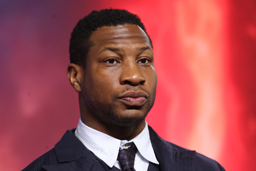 Jonathan Majors in a formal suit at a public event