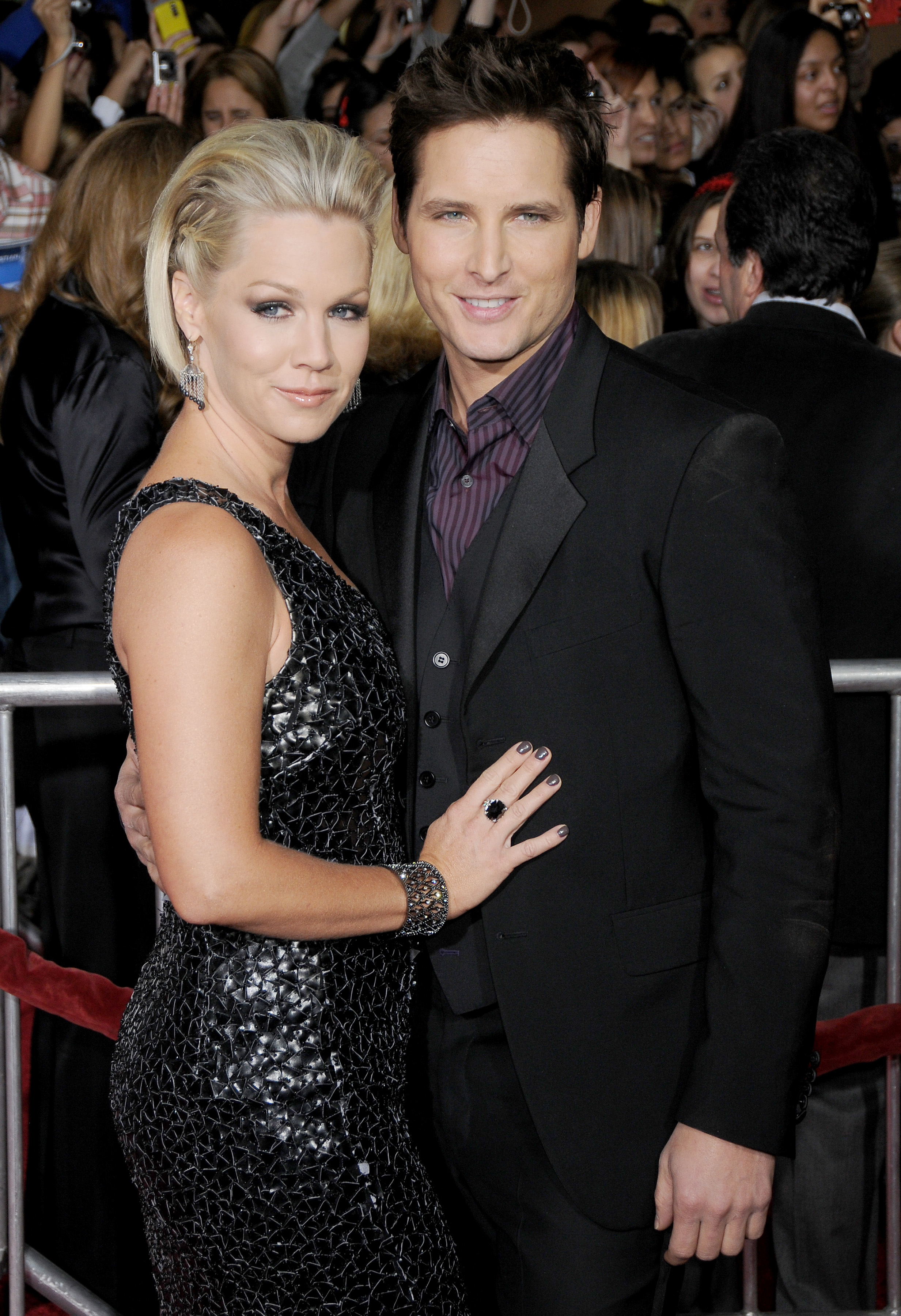 Jennie Garth and Peter Facinelli pose together on the red carpet, with Jennie in a sequined dress and Peter in a suit
