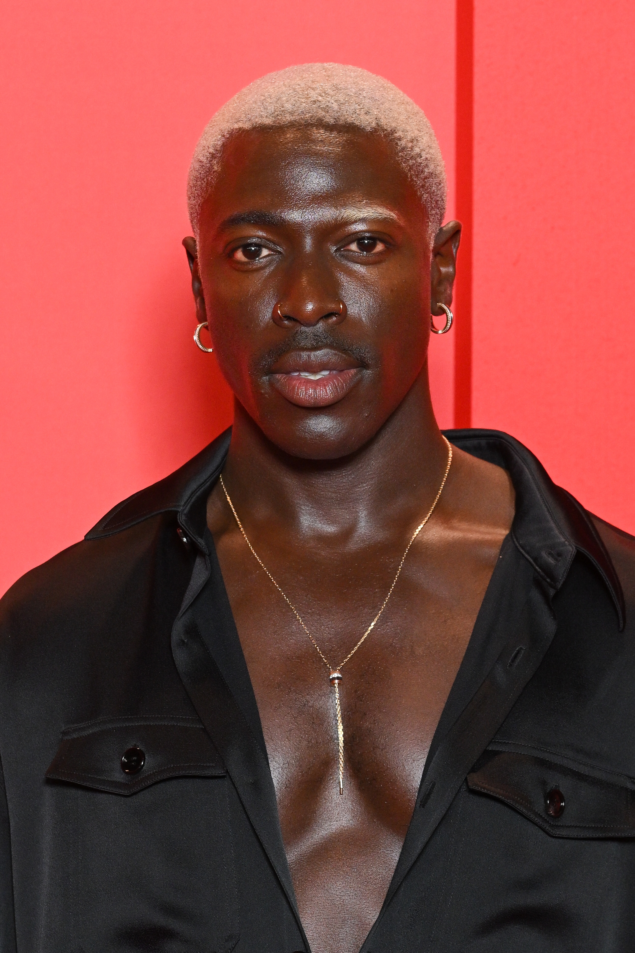 Moses Sumney wearing a button-up shirt with his chest partially exposed at the premiere of &quot;The Idol&quot;