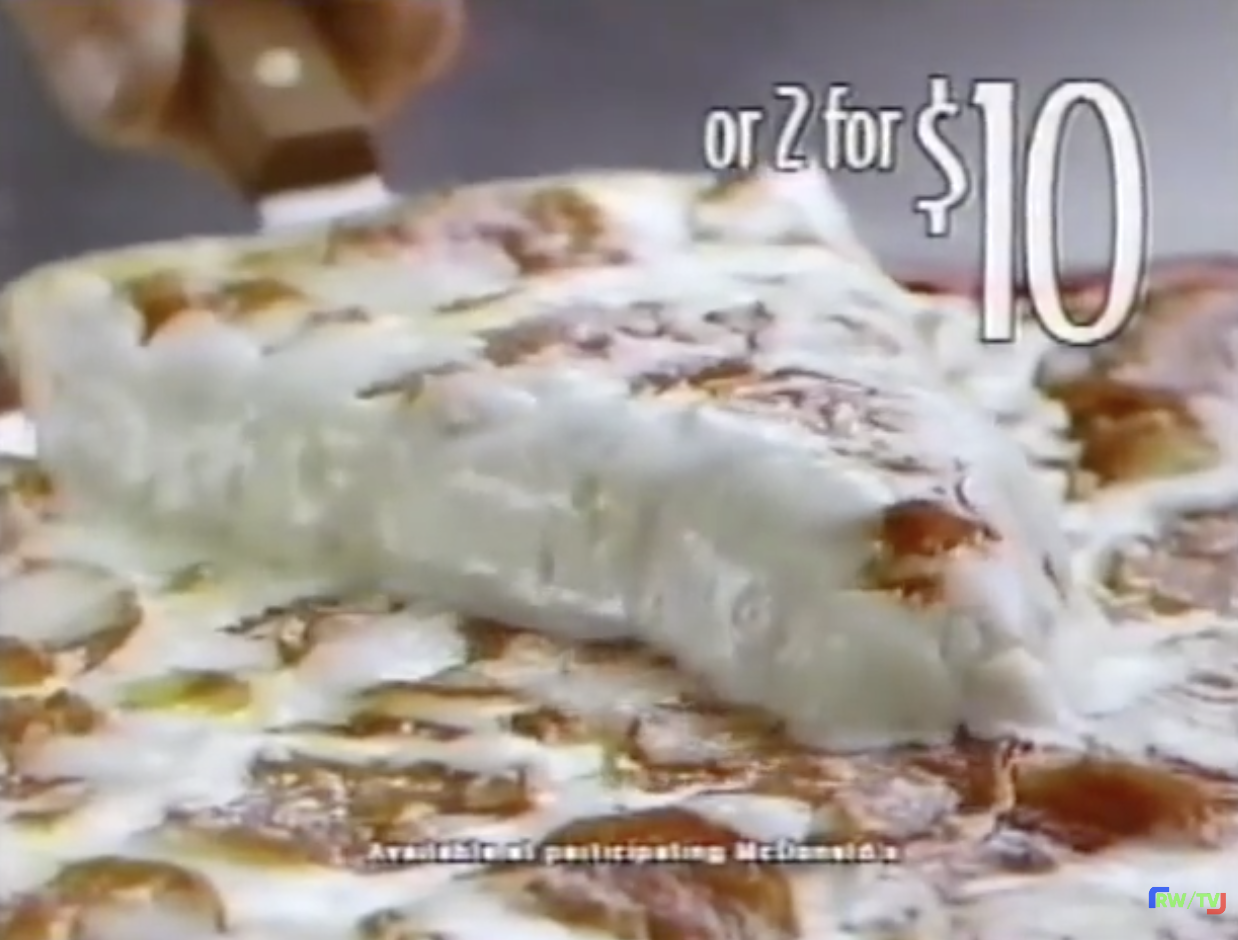 A slice of pizza being lifted, with text displaying &quot;or 2 for $10.&quot; Available at participating McDonald&#x27;s is noted below
