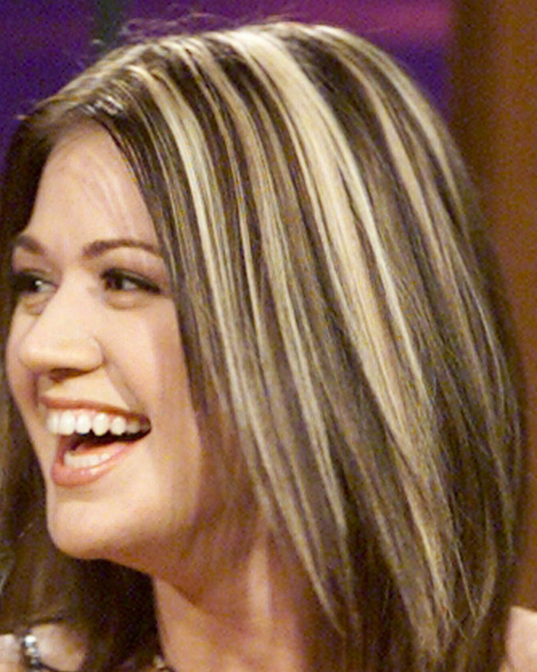 A close side angle of Kelly Clarkson showing her chunky highlights and layered hair
