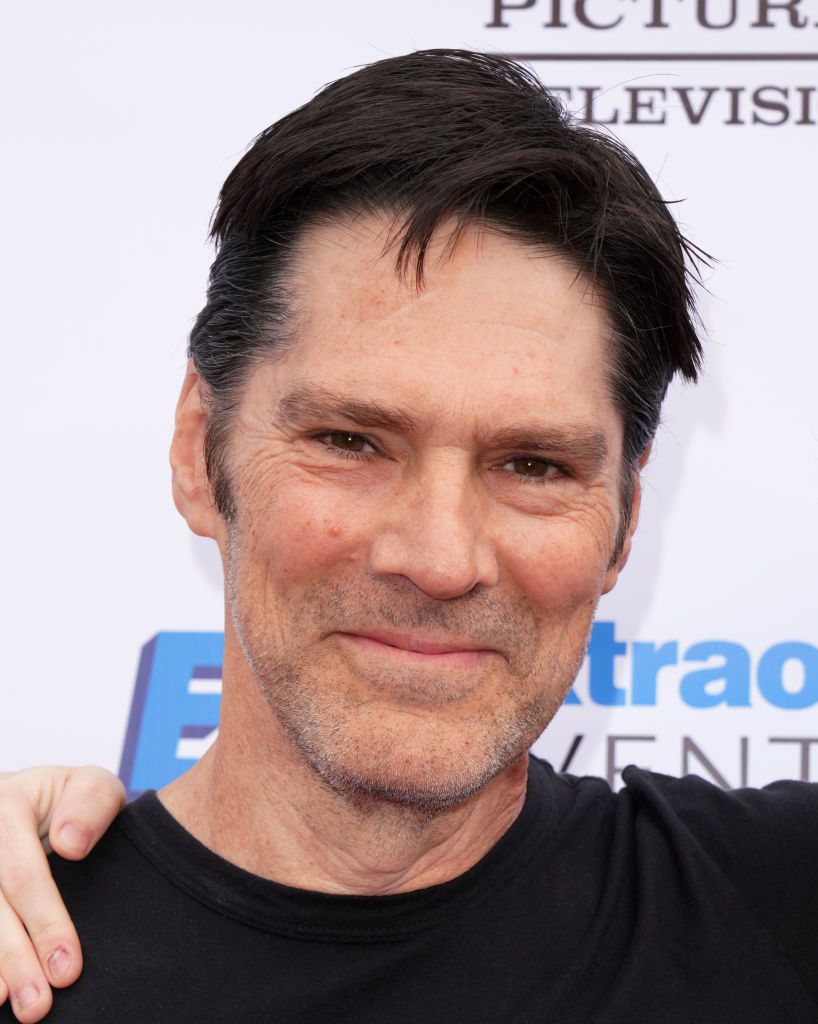 A close-up photo of Thomas Gibson smiling at an event, wearing a black shirt