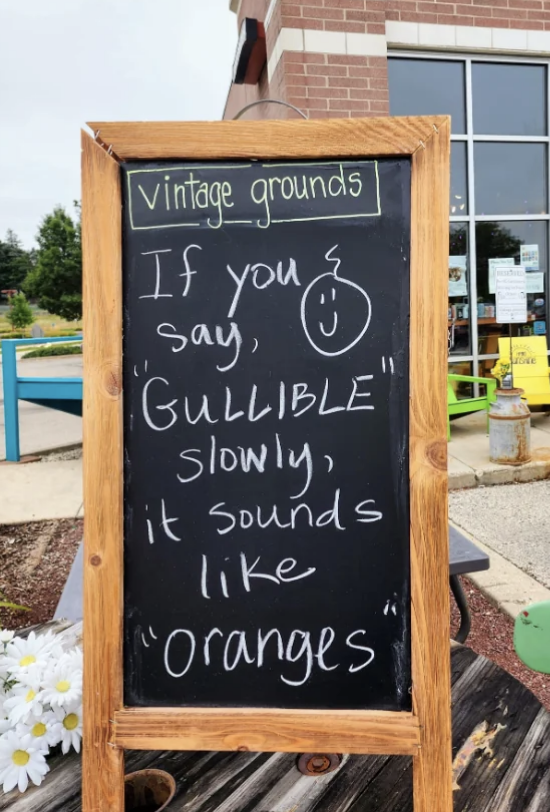Chalkboard outside Vintage Grounds coffee shop reads: &quot;If you say &#x27;GULLIBLE&#x27; slowly, it sounds like &#x27;oranges&#x27;&quot; with a smiley face