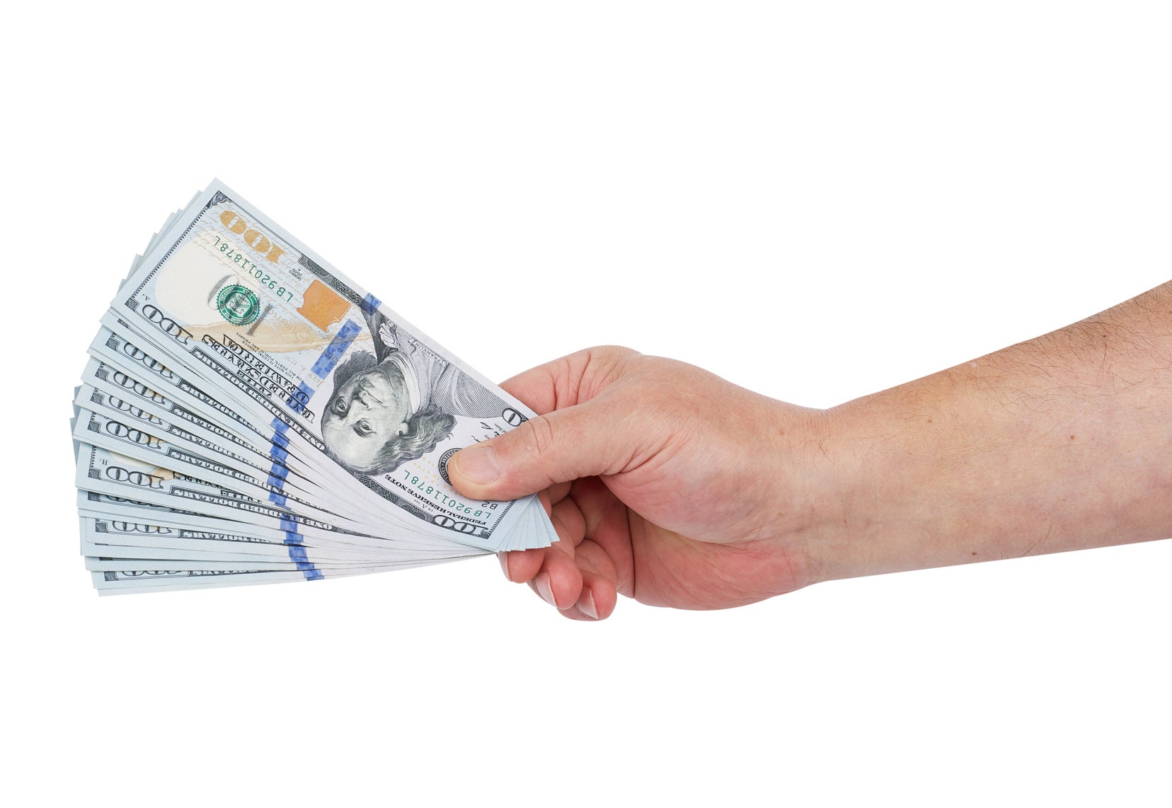 A hand holding a fanned-out stack of US hundred-dollar bills, isolated on a white background