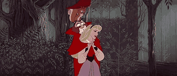 Aurora from &quot;Sleeping Beauty&quot; joyfully walks through a forest with bird and owl on her shoulders.