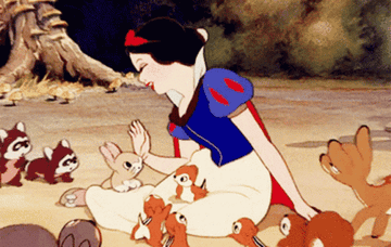 Snow White sitting on the ground, surrounded by various woodland animals, including bunnies, raccoons, and deer, in a forest setting.