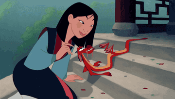 Mulan kisses Mushu&#x27;s head in &quot;Mulan.&quot;