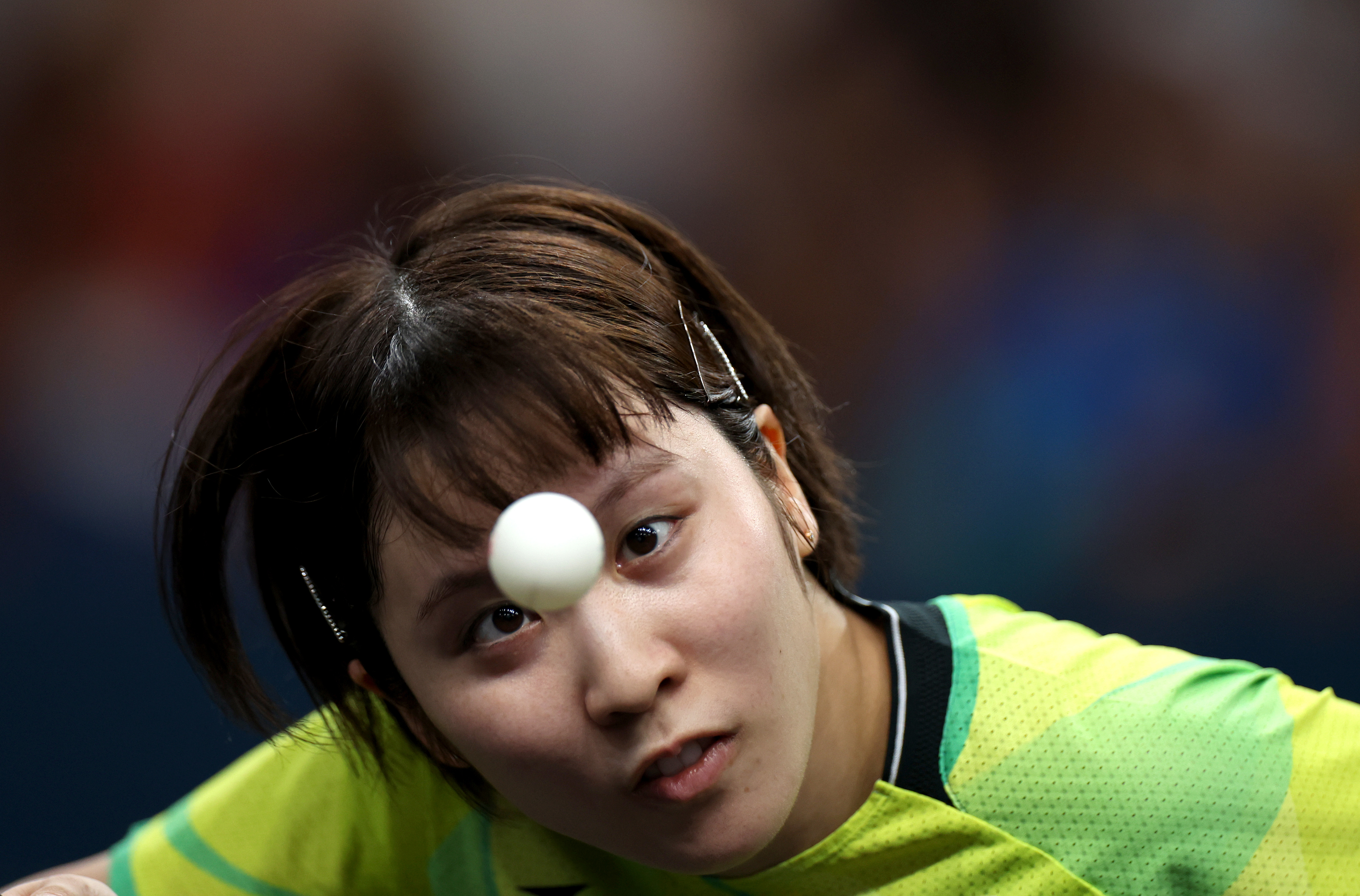 Focused athlete in action during a table tennis game, aiming at the ball with intense concentration