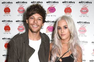 Louis Tomlinson in a casual jacket and jeans, and Lottie Tomlinson in a black bralette and white pants, posing at a Matchbox event backdrop