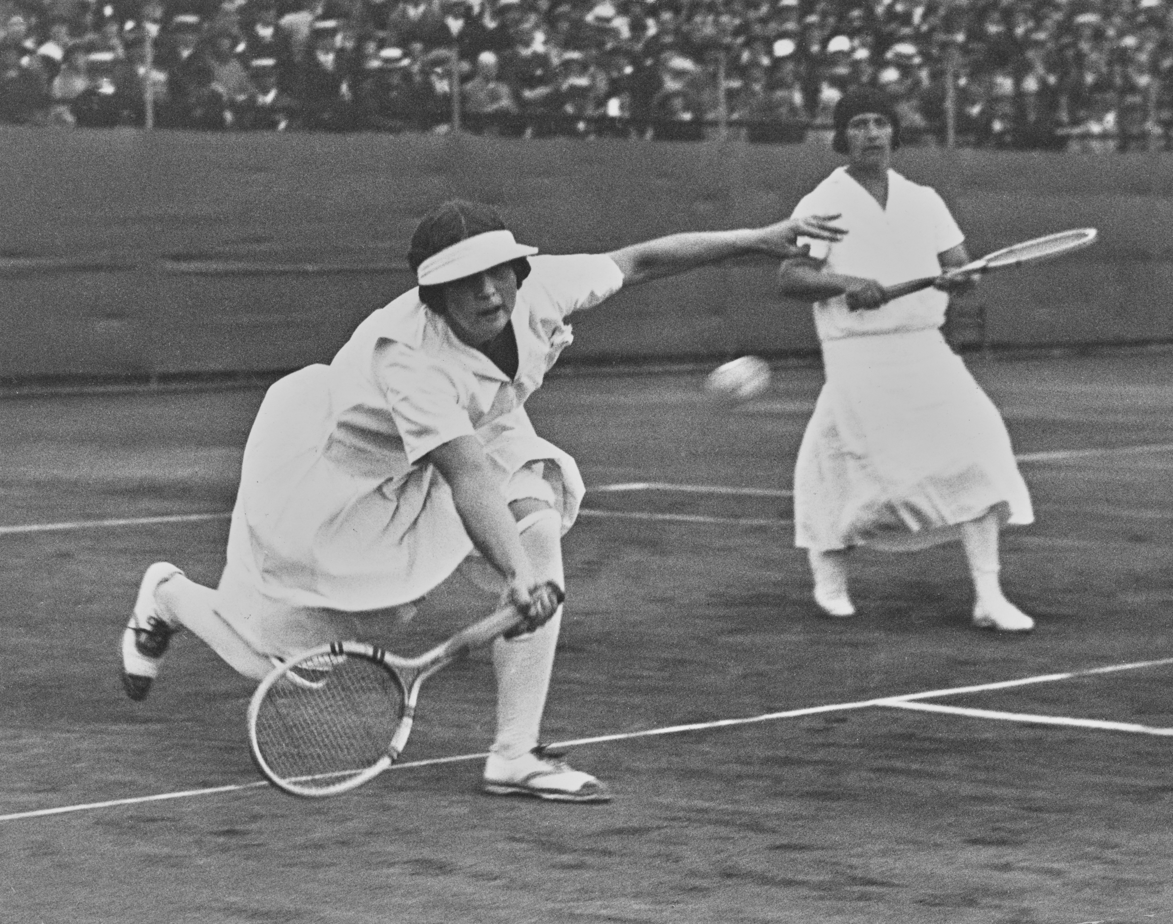 Tennis player Helen Wills and her coach, Hazel Wightman, competing in an intense game of tennis