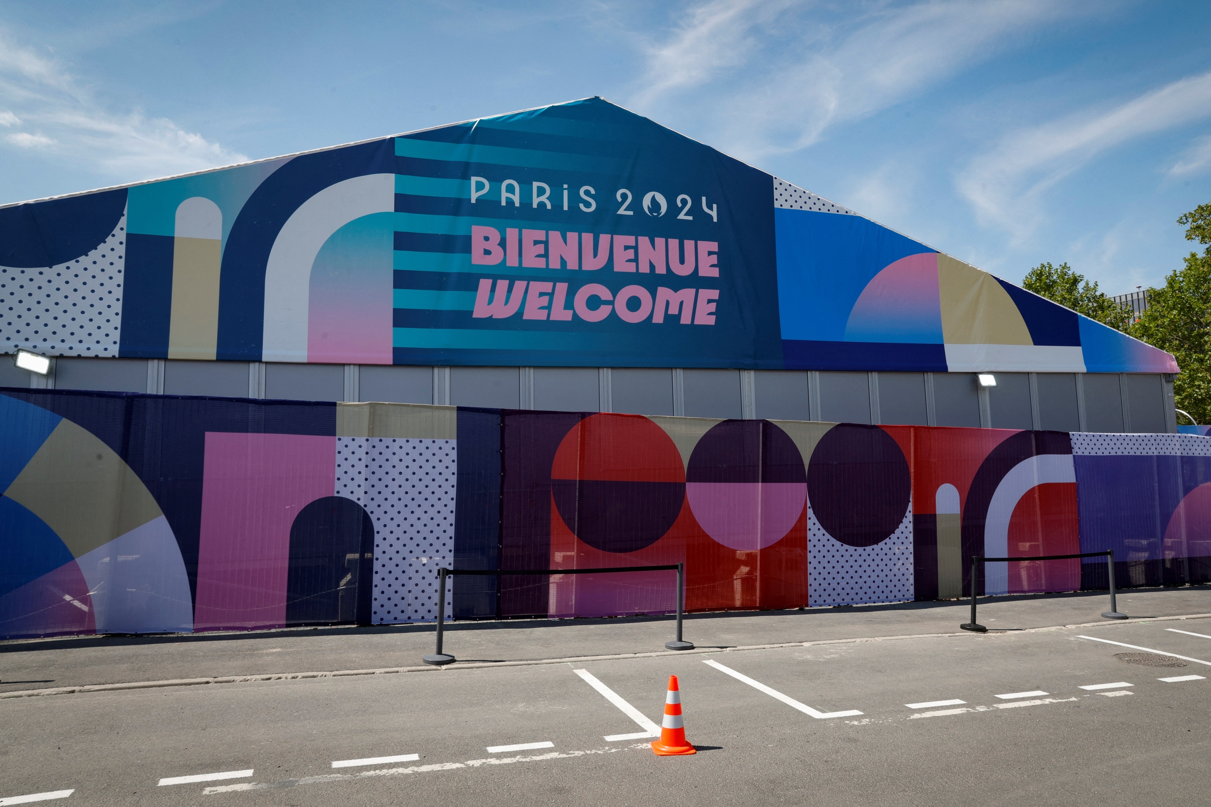 Large pavilion with a sign that reads &quot;Paris 2024 Bienvenue Welcome&quot; ahead of the Paris 2024 Olympics