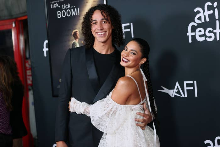 Vanessa Hudgens hugs Cole Tucker at AFI Fest. Vanessa wears a lace dress, and Cole dons a suit