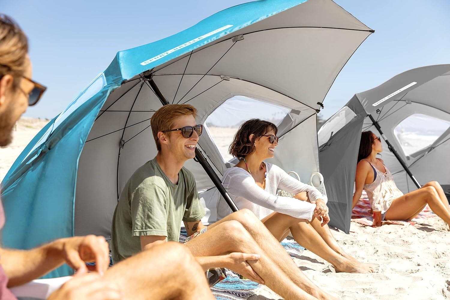 models on a beach using the umbrella