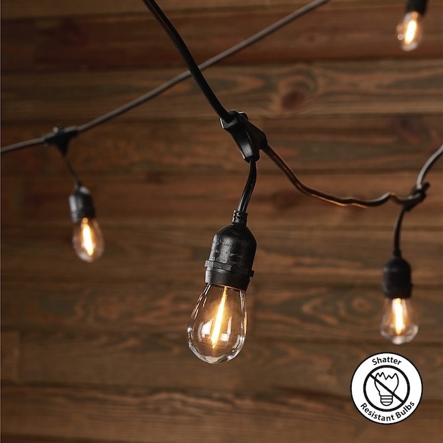 String lights with shatter-resistant bulbs hanging against a wooden wall backdrop