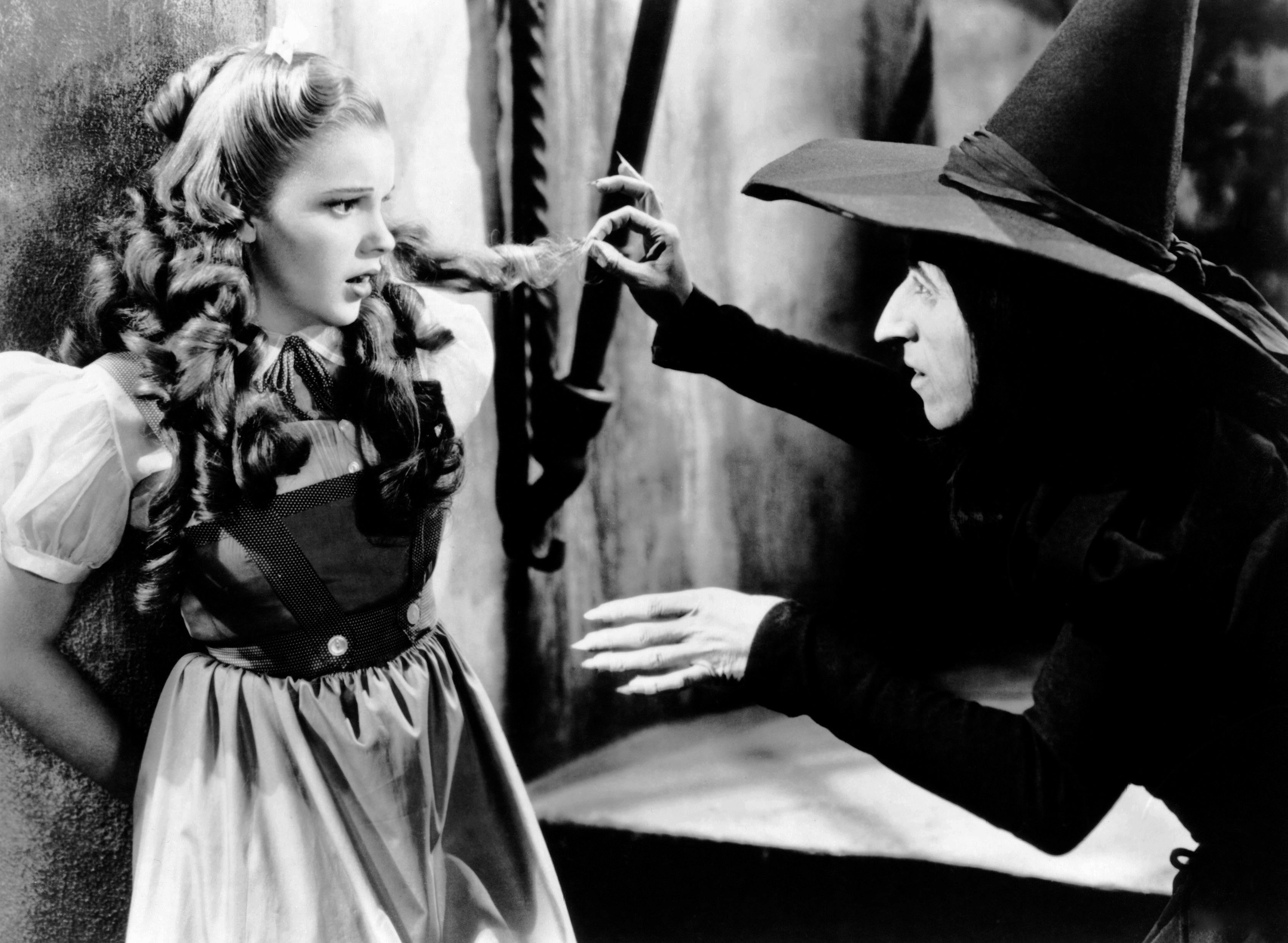 Dorothy, played by Judy Garland, is being threatened by the Wicked Witch of the West, portrayed by Margaret Hamilton, in a scene from &quot;The Wizard of Oz.&quot;