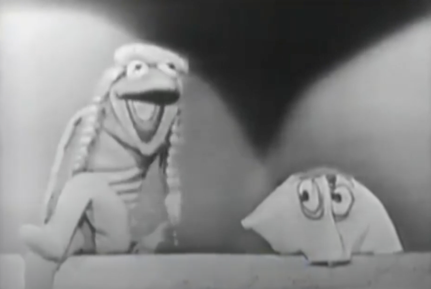 Jim Henson&#x27;s puppets, Kermit the Frog and Yorick, from a classic black-and-white television appearance, with Kermit wearing a happy expression