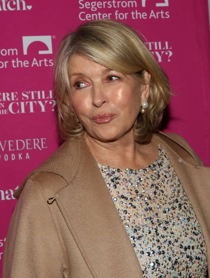 Martha Stewart at a red carpet event wearing a sequin-embellished top and a beige coat, in front of a Segerstrom Center for the Arts backdrop