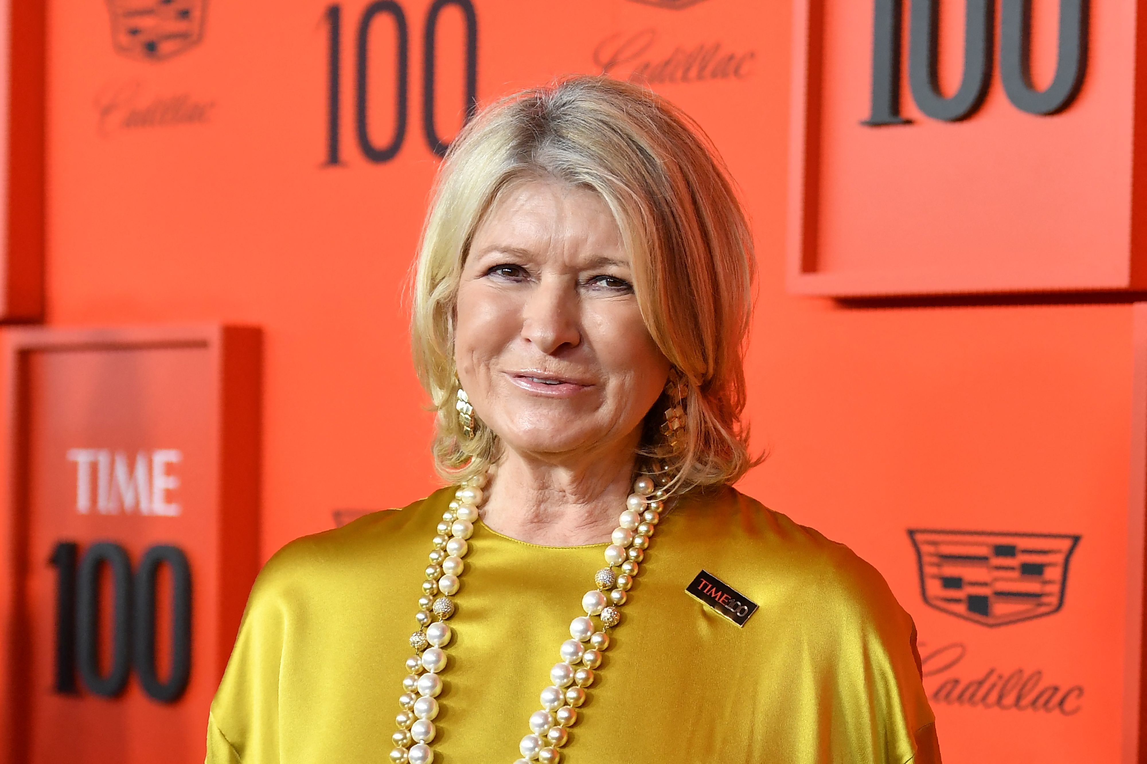 Martha Stewart on the red carpet at the TIME 100 event, wearing a stylish dress with a long string of pearls