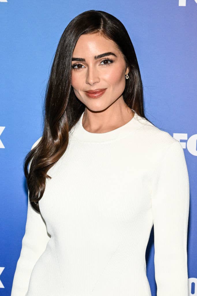 Olivia Culpo poses in a white dress at a Fox event