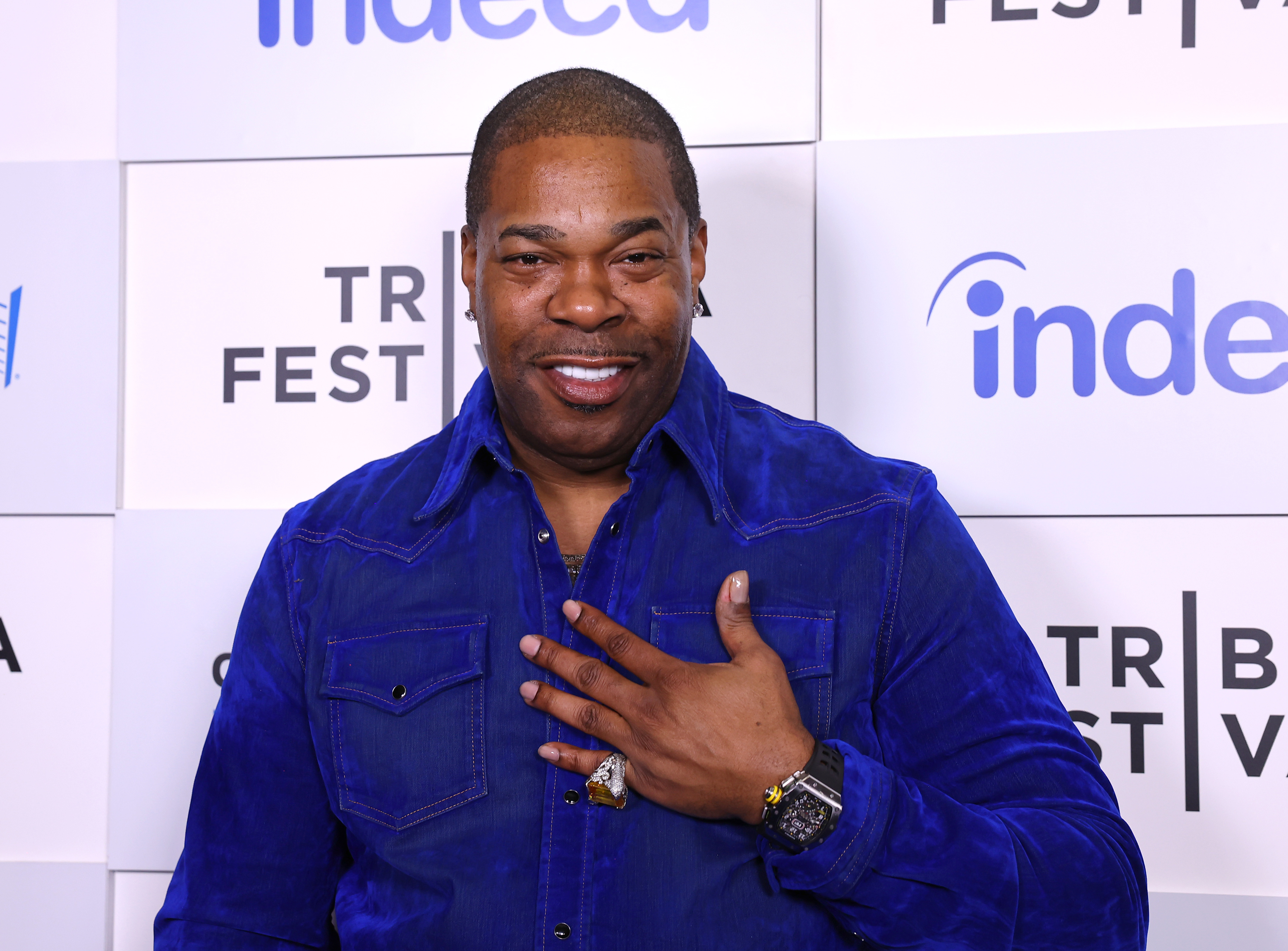 Busta Rhymes poses on the red carpet at the Tribeca Festival, wearing a stylish button-up shirt