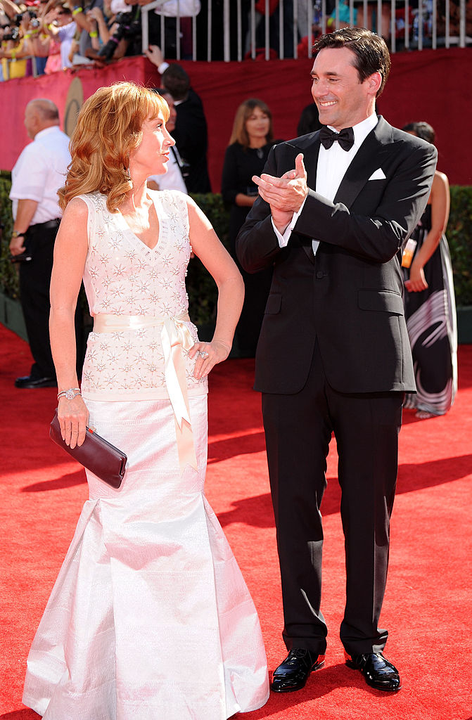 Kathy Griffin in an elegant gown and Jon Hamm in a tuxedo on the red carpet