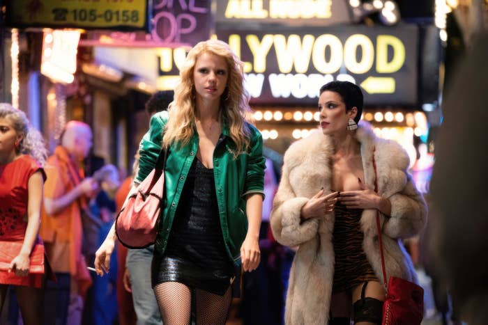 Mia Goth and Halsey walking on a street together in a scene from &quot;MaXXXine&quot;