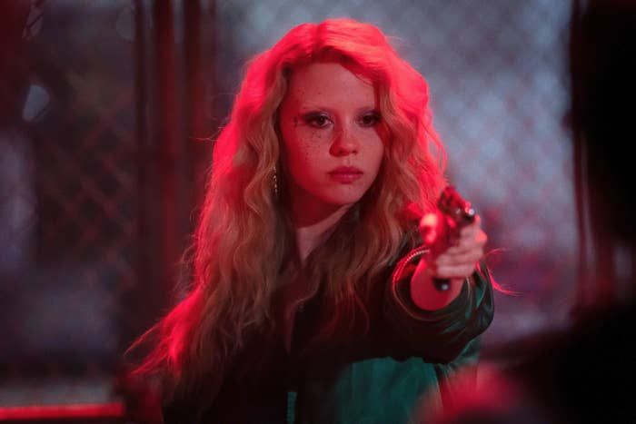 Mia Goth points a gun in a scene from &quot;MaXXXine&quot;