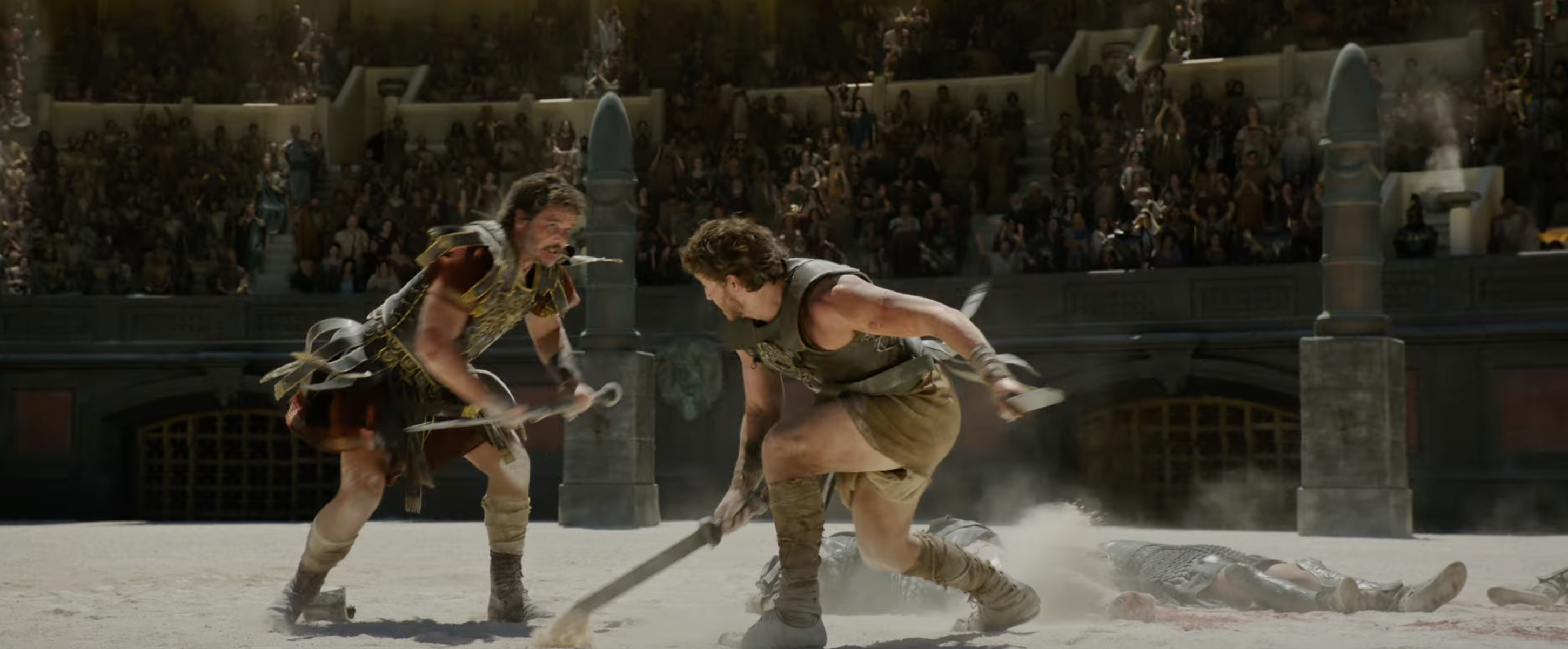 Two gladiators fight in an ancient arena, surrounded by spectators. One combatant aggressively swings a weapon while another defends on the ground