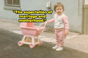 A young child standing outdoors, holding a pink toy stroller. Text in the image reads, "The expectation of marriage and motherhood."