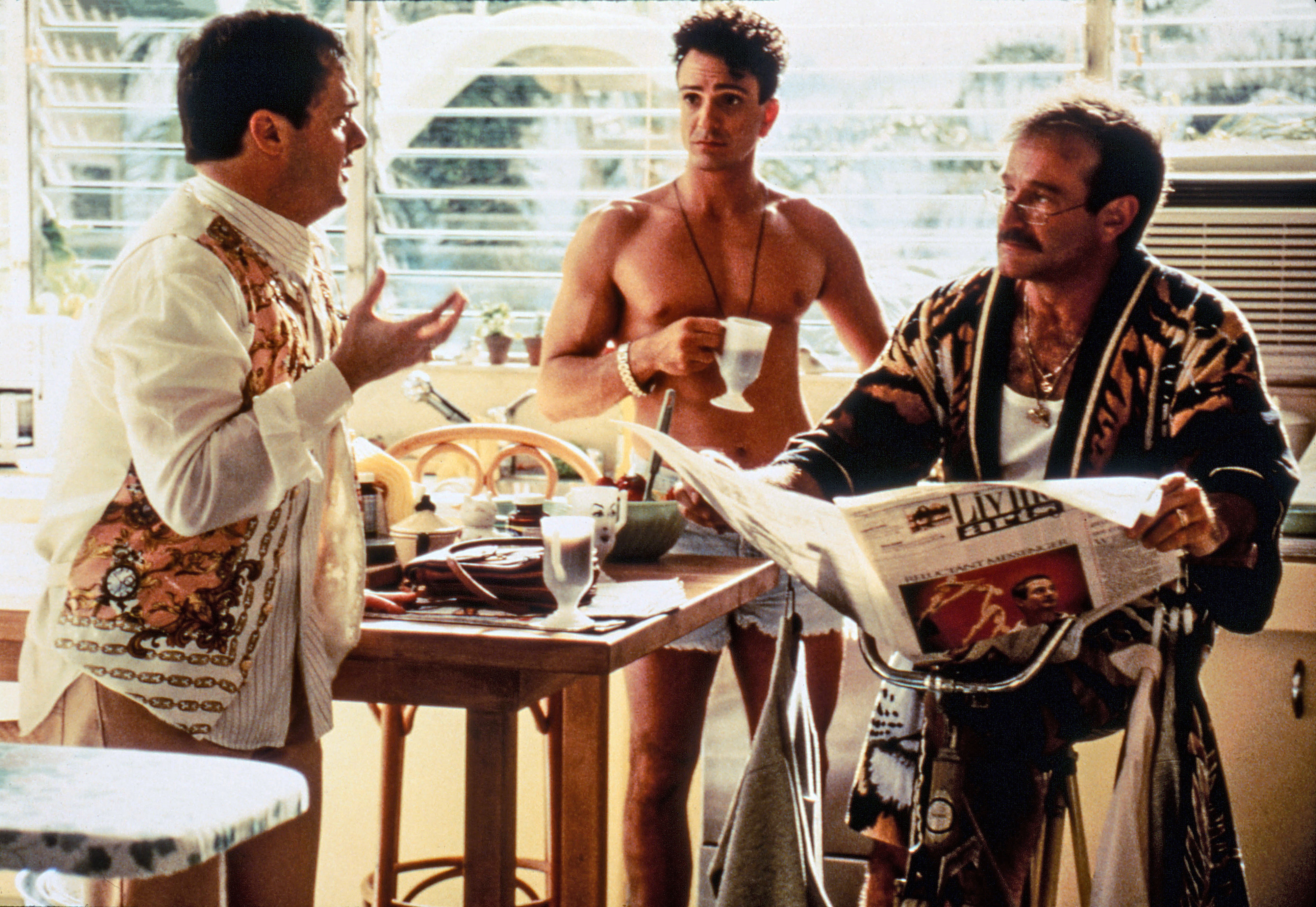 Nathan Lane, Hank Azaria, and Robin Williams in a kitchen scene from &quot;The Birdcage.&quot; Nathan Lane is gesturing, Hank Azaria is holding a cup, and Robin Williams reads the paper