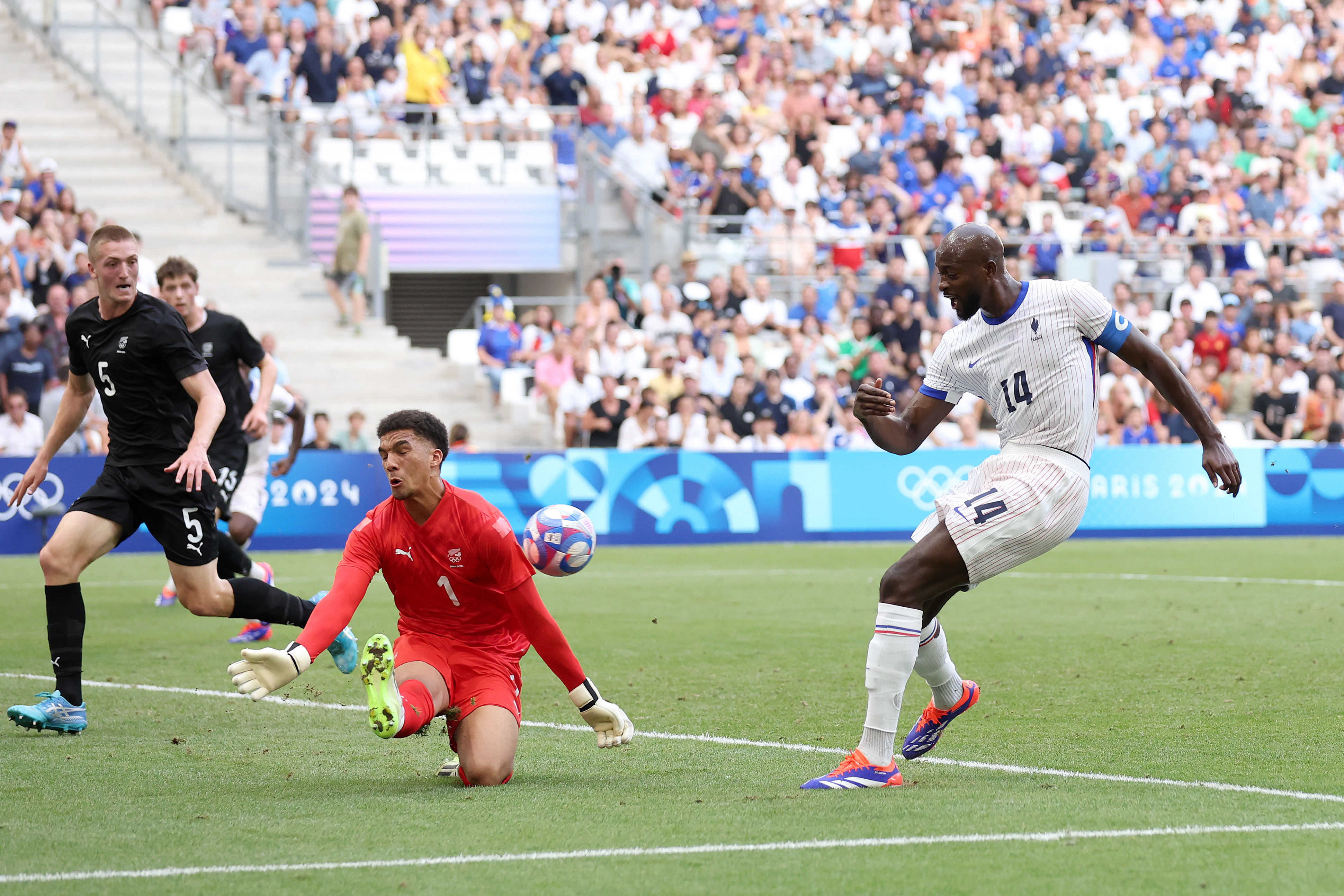 Soccer match action: France&#x27;s Marcus Thuram attempts a goal against New Zealand with goalkeeper Michael Woud and defender Nando Pijnaker in defensive positions