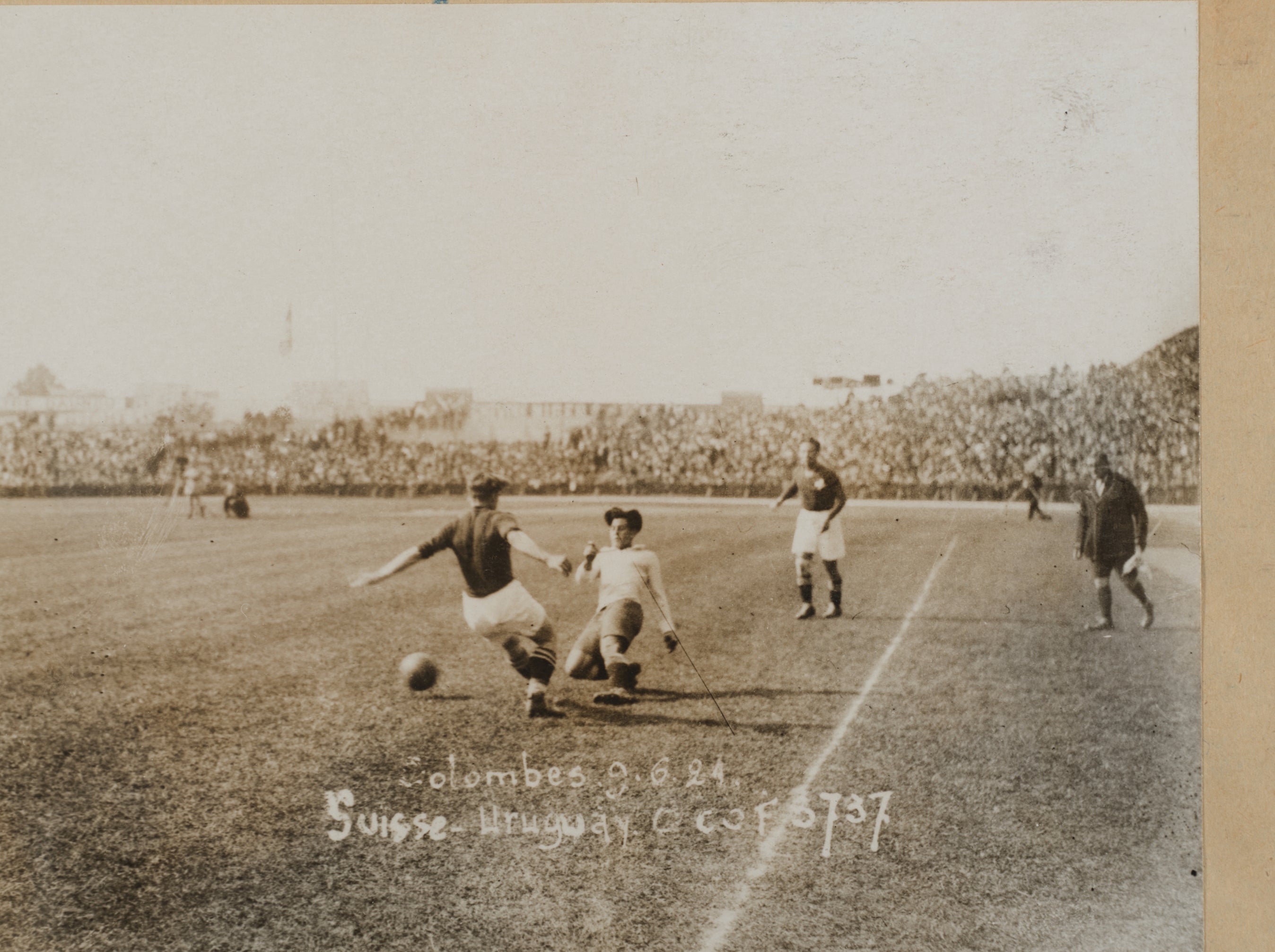 Historic photo of a soccer match between Switzerland and Uruguay on May 28, 1924. Players are in action on the field with a stadium full of spectators in the background