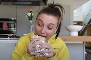 Emma Chamberlain eating a burrito wrapped in foil