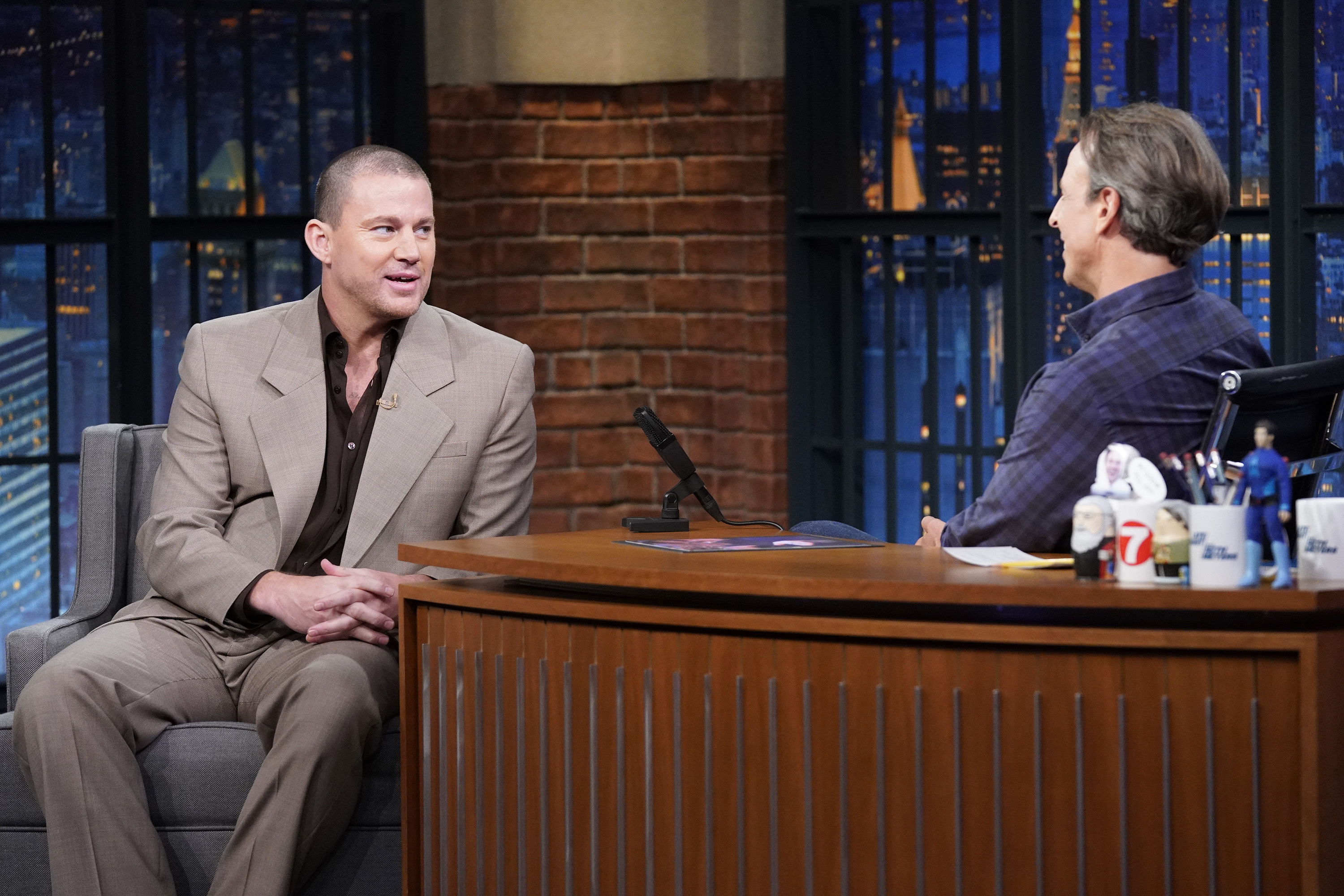 Channing Tatum in a suit talks to host Seth Meyers on the set of &quot;Late Night with Seth Meyers&quot;