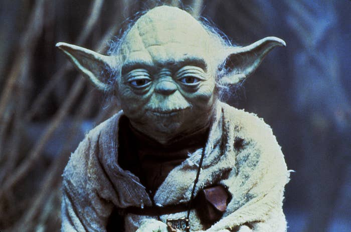 Yoda from Star Wars, wearing a robe, in a scene from the movie